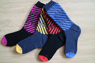 A picture of Debra Kinsey Knits - Gneiss Colourwork Socks, by Debra Kinsey, on a white background.